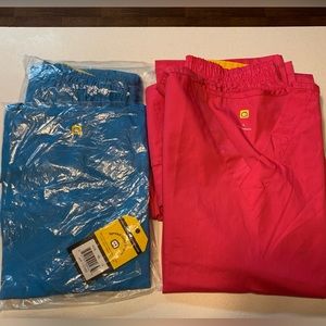 2 pair of NWT wonder wink scrubs size LARGE. Pink and blue